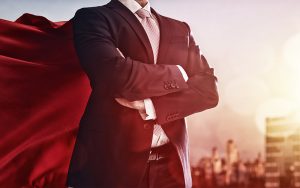 Businessman confidently posing with a cape