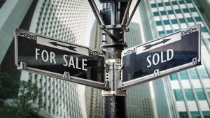 Street signs with the words "For Sale" and "Sold"